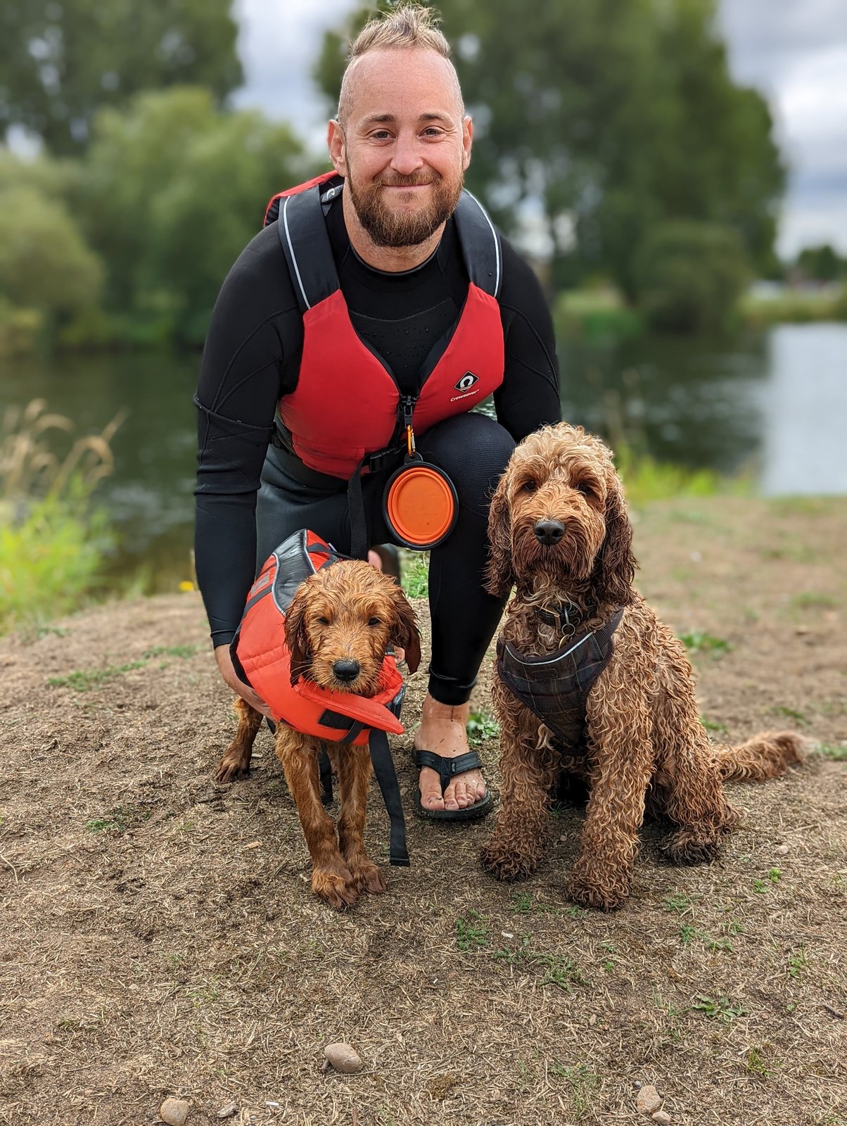 Chris with his two dogs, Bundaberg and Cooper, by a river